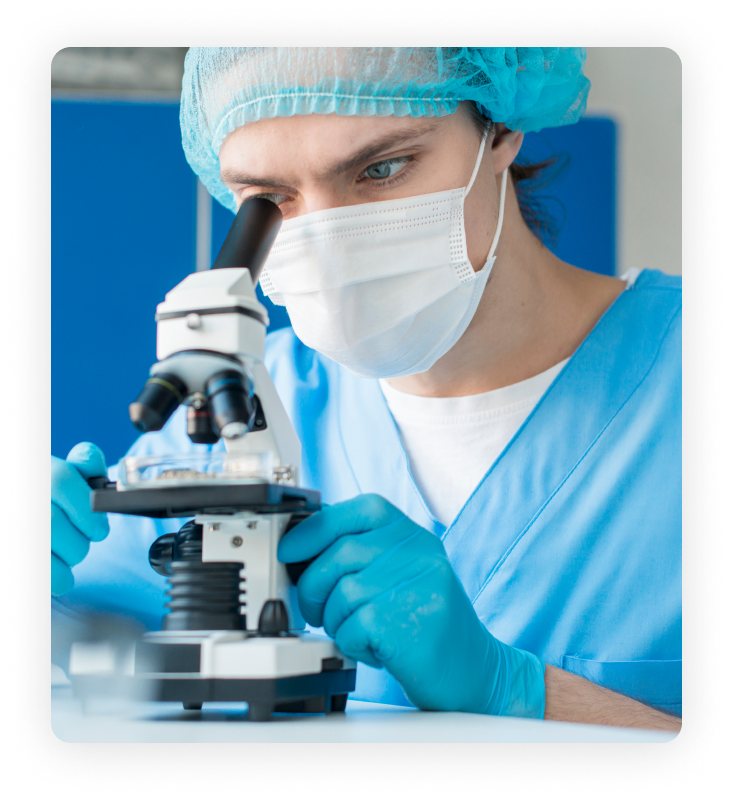 Image of scientist looking through microscope
